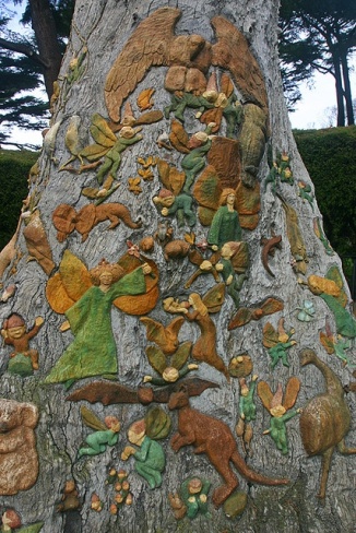 The Fitzroy Garden in Melbourne Australia has an area with "Fairy Trees" that were carved and painted (before 1945) and magical.